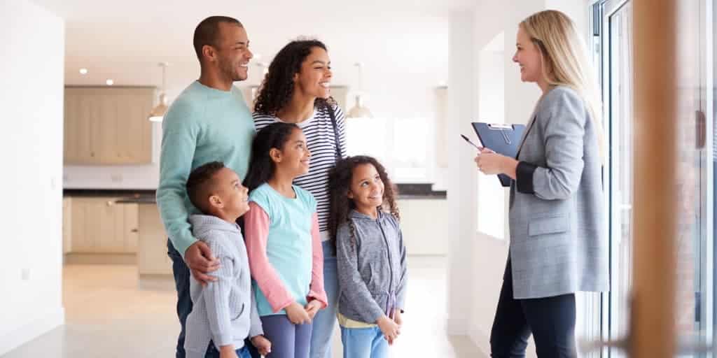 female-realtor-showing-family-interested-in-buying
